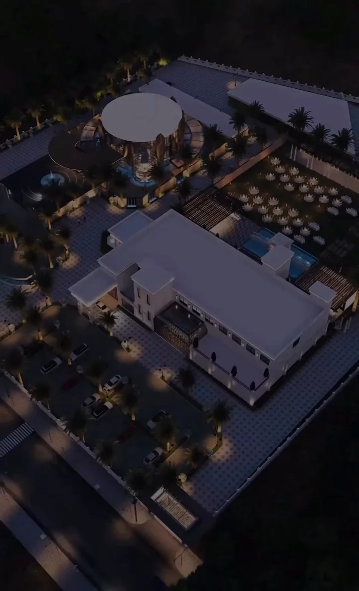 Visualisation: Aerial view of The Ellysiaa's five-acre destination at night, showing pavilions, lawns and the main building