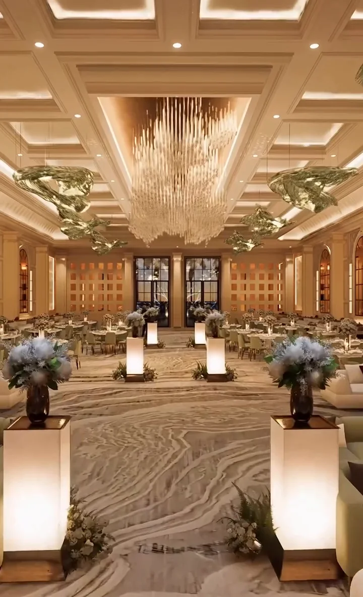 Visualisation: Grand celebration hall with a cascading crystal chandelier and illuminated floral plinths
