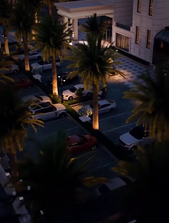 Visualisation: The Ellysiaa at night — illuminated arrival court lined with palms