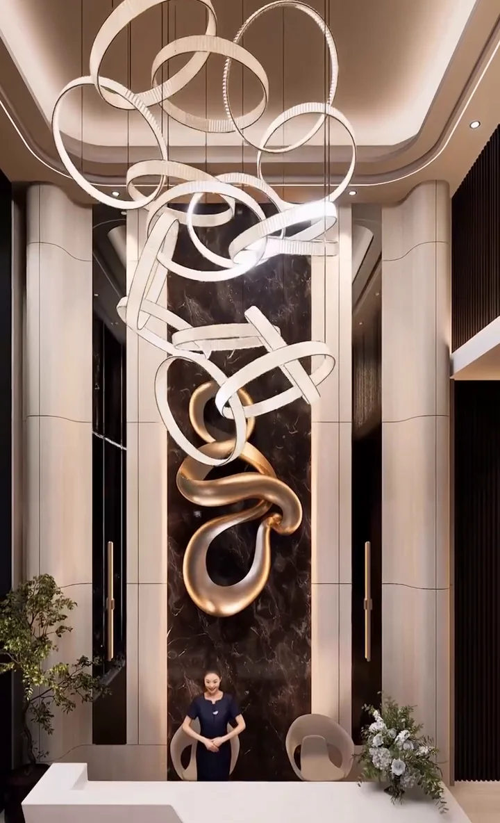 Visualisation: Double-height lobby with a sculptural ring chandelier and bronze artwork