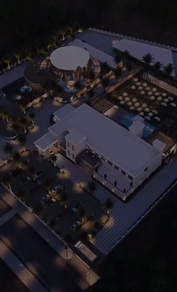 Aerial view of The Ellysiaa's five-acre destination at night, showing pavilions, lawns and the main building